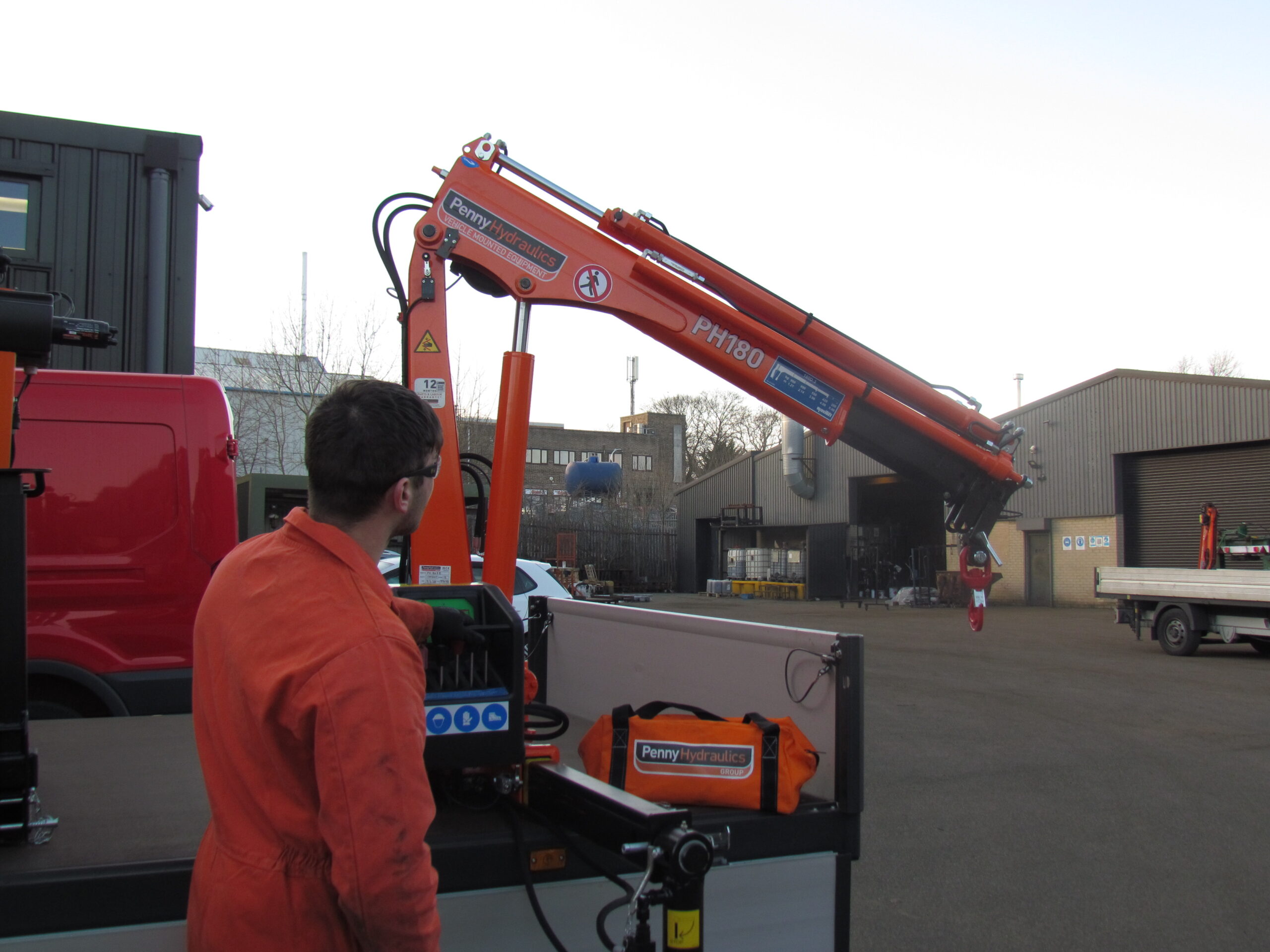 A distorted image showing construction equipment, vehicles, and at least one person outdoors near a building, with digital glitches and coloured bands obscuring much of the scene.