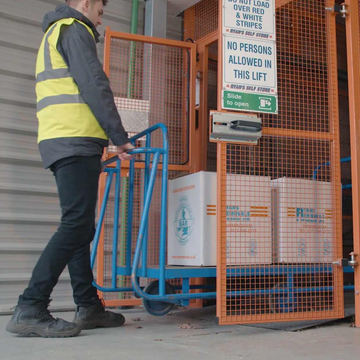 Mezzlift Solution Loading Lift taking trolley goods into mezzanine lift to transport between floors for Ryan's Removals.